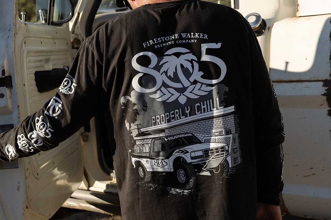 Man wearing the Heat Wave x 805 Properly Chill Long Sleeve T-Shirt - Black showing the back side