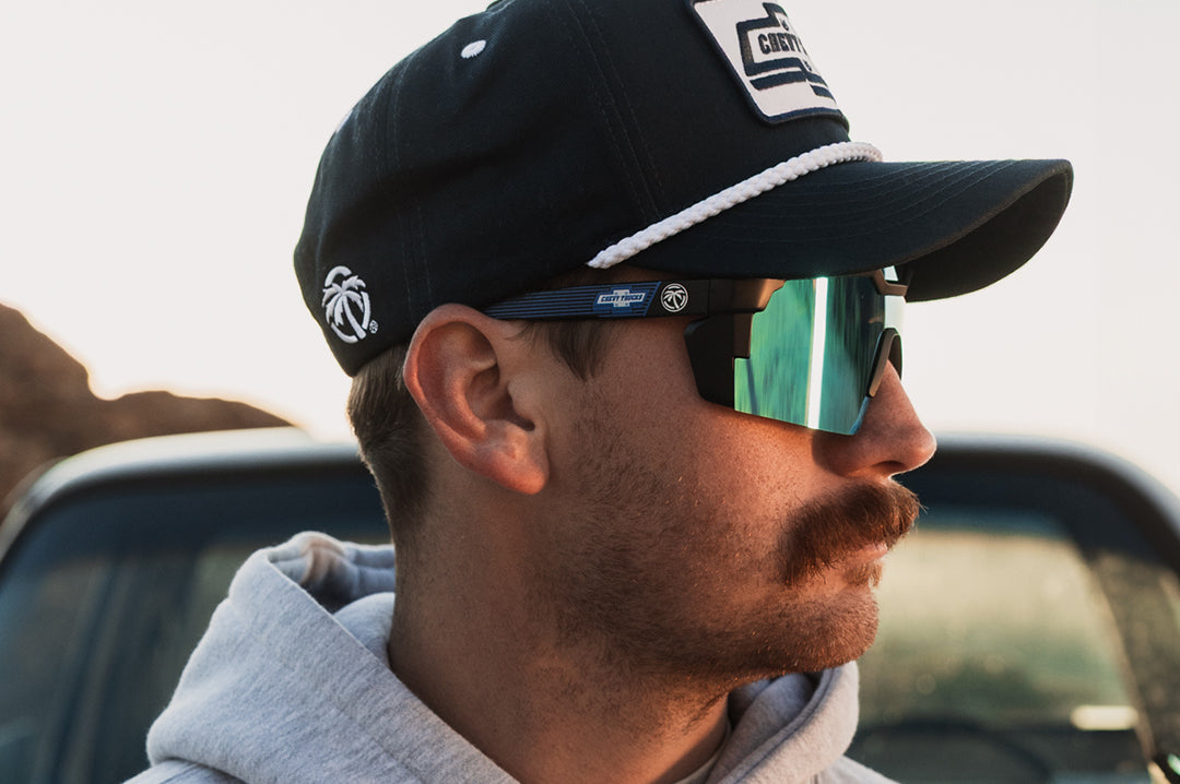 male model wearing Heat Wave Visual Future Tech Sunglasses with black frame, Chevy Truck print arms and Galaxy lens.