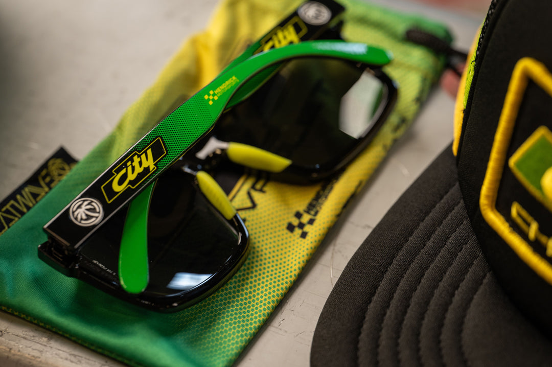 Lying on a metal table is the City of Chevrolet X HWV Z87 Vise Sunglasses.