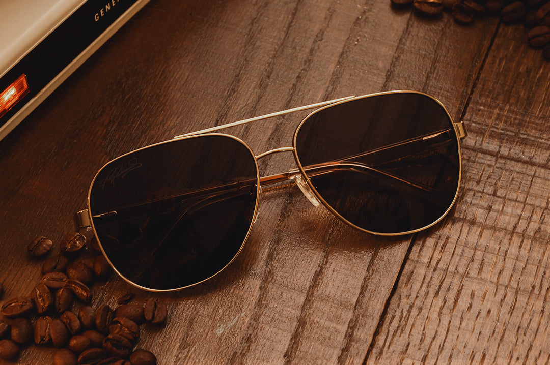 Close up of the Incline Sunglasses: Hendrick Motorsports | Tim Richmond 25 Folgers on a wood table