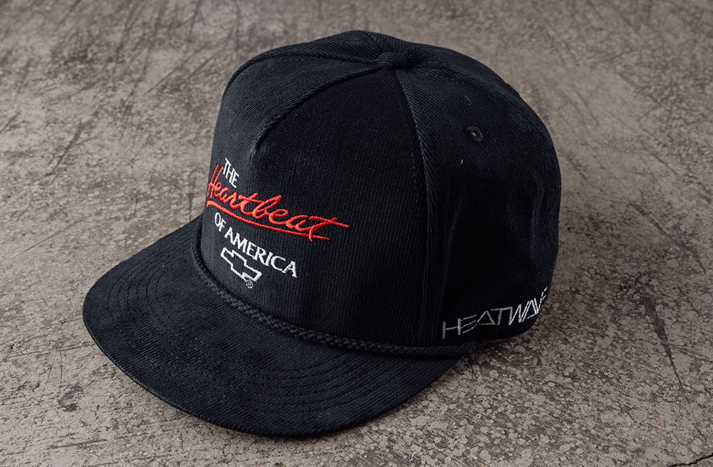 Lying on the Concrete is the Heat Wave Visual X Chevrolet Heart Beat of America Black Corduroy Hat.