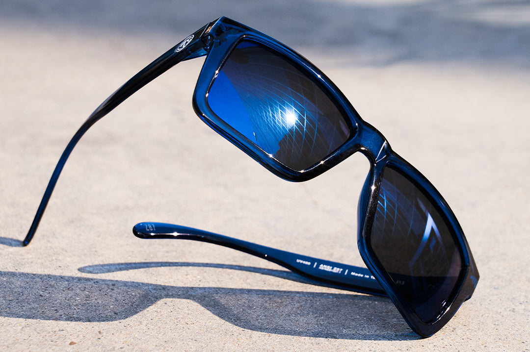 Sitting on the ground is the Heat Wave Visual Z87 Vise with neon blue frame and coastal blue lenses. 