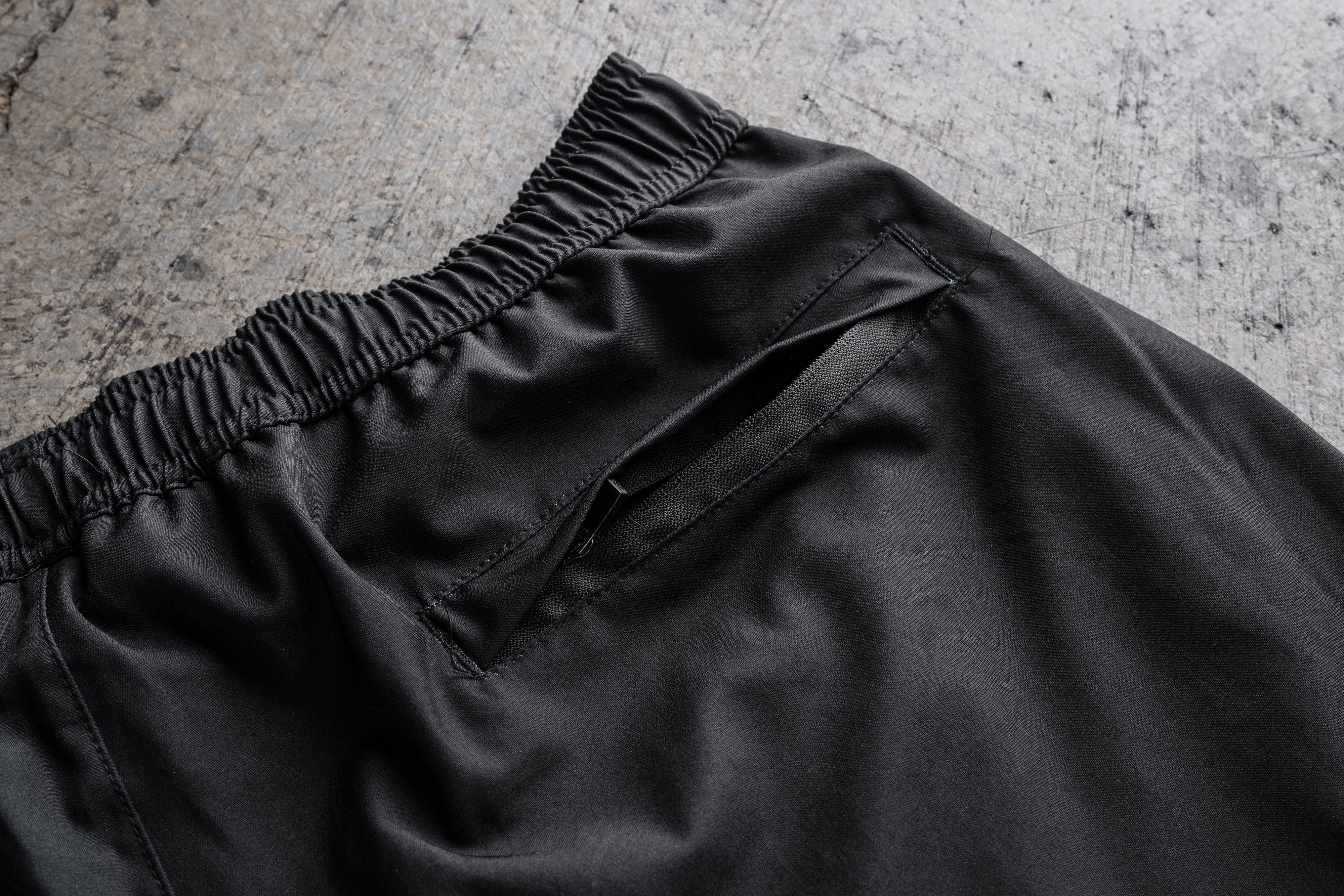 Close-up of the zipper pocket on the Heat Wave Visual White Flame Performance Shorts.