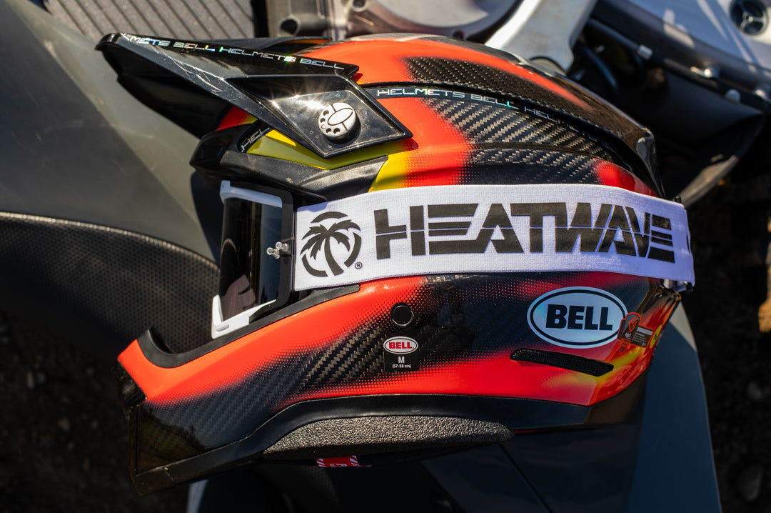 The Heat Wave Visual MXG 250 Motosport Goggle in the billboard icon white with photochromic lens on a moto helmet.