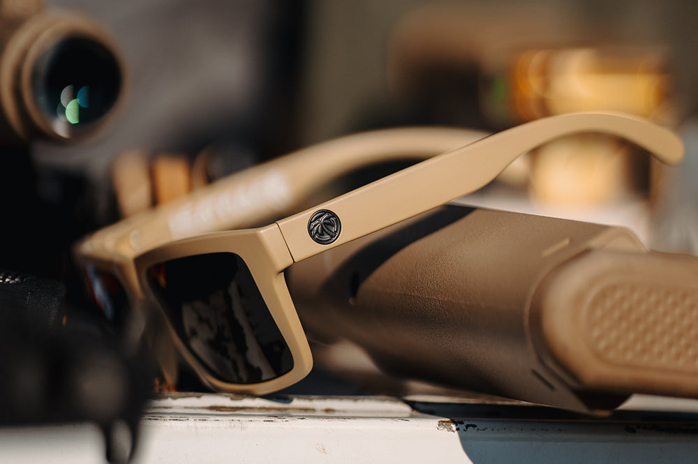 Heat Wave XL Vise Tan sunglasses with ultra black lenses on a blurred background