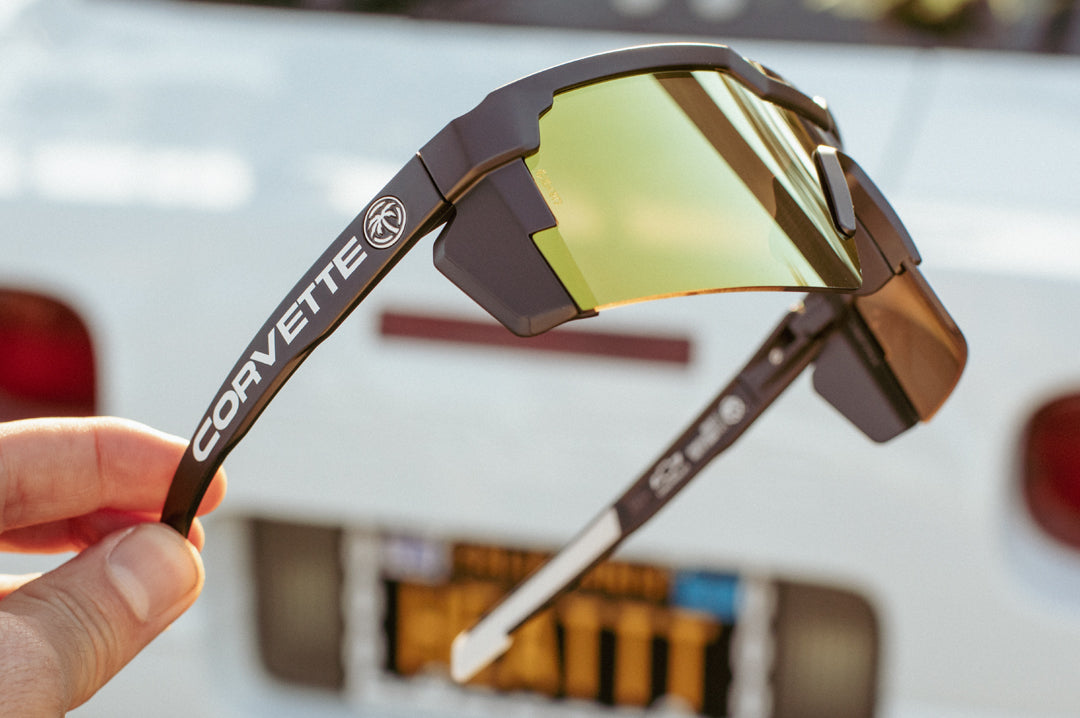 Side view of the Heat Wave Visual Future Tech Sunglasses with black frame, corvette print arms and gold lens.