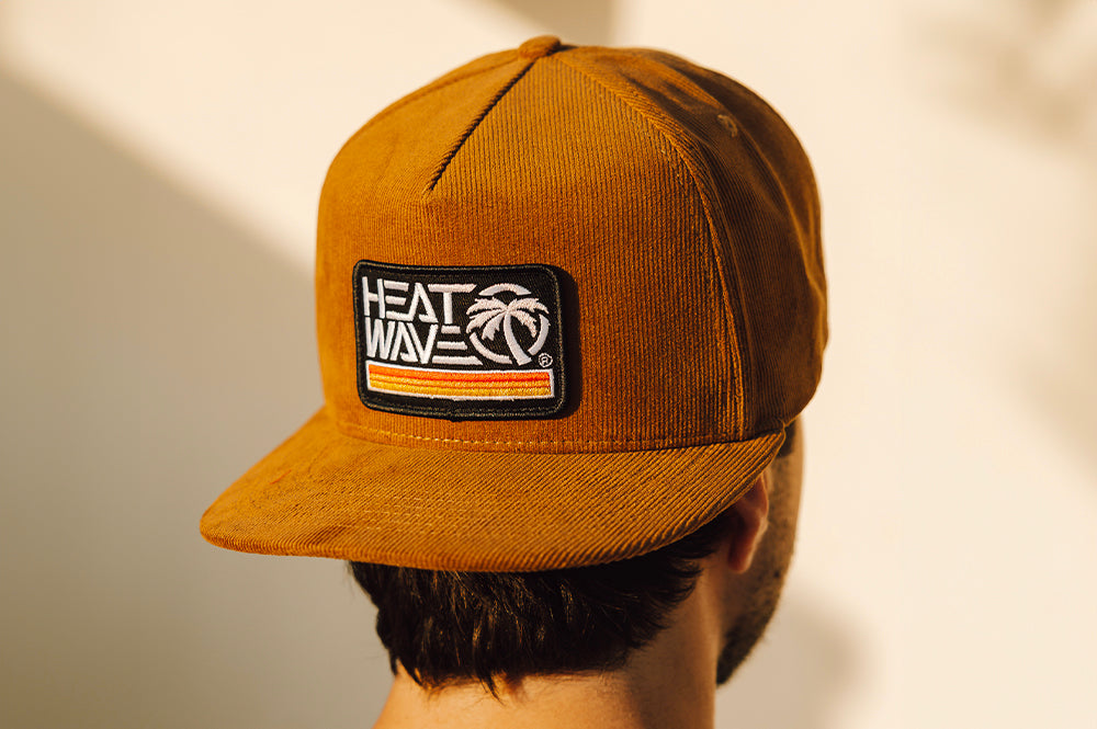 Man wearing the Heat Wave Visual Retro Stripe Brown Hat.