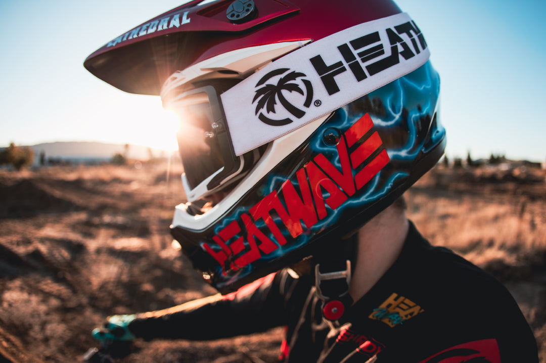 Close up of a dirt biker wearing the Heat Wave Visual MXG 250 Motosport Goggle in the billboard icon white colorway. 