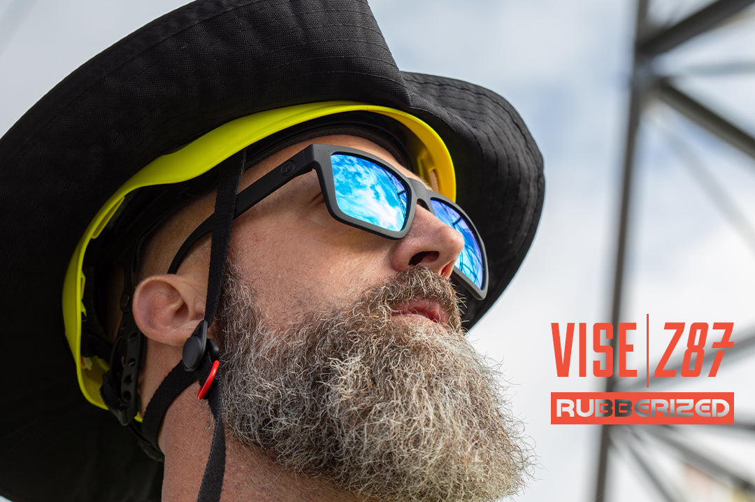 An electrician out in the field wearing the Heat Wave Visual XL Vise Z87 Sunglasses with rubberized frame and galaxy blue lenses.