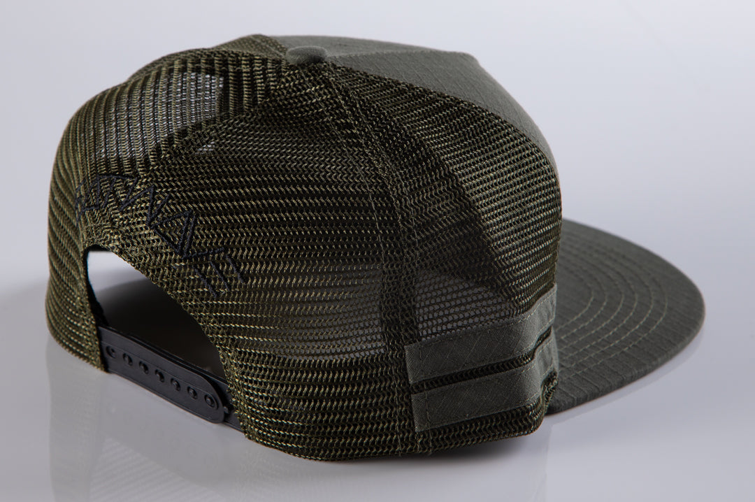 Back of Heat Wave Visual od green trucker hat with socom patch.