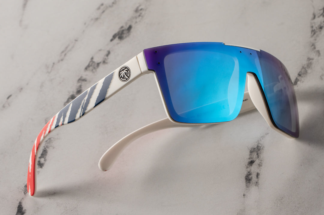 Sid eof Heat Wave Visual Quatro Sunglasses with white frame, red white and blue print arms and galaxy blue lens.