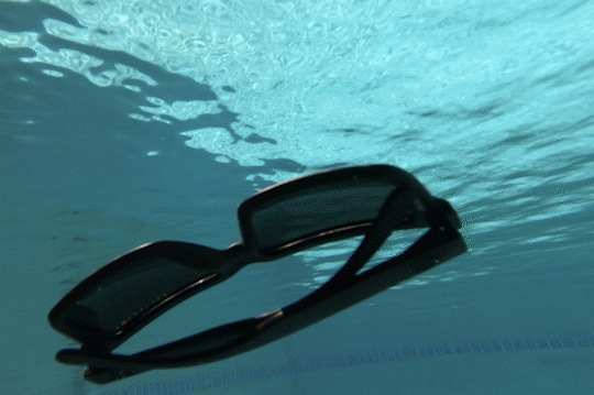GIF of Heat Wave Visual XL Vise Floating Sunglasses floating up to the surface in a swimming pool.