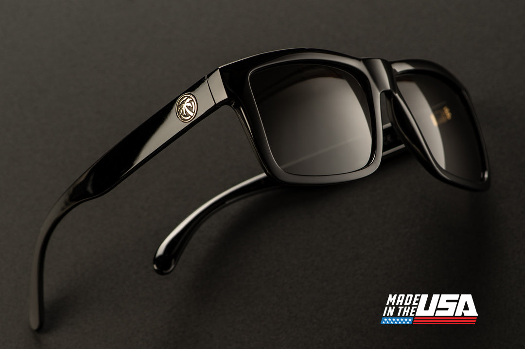 Side view of Heat Wave Visual USA made Vise Sunglasses with gloss black frame and black lenses.