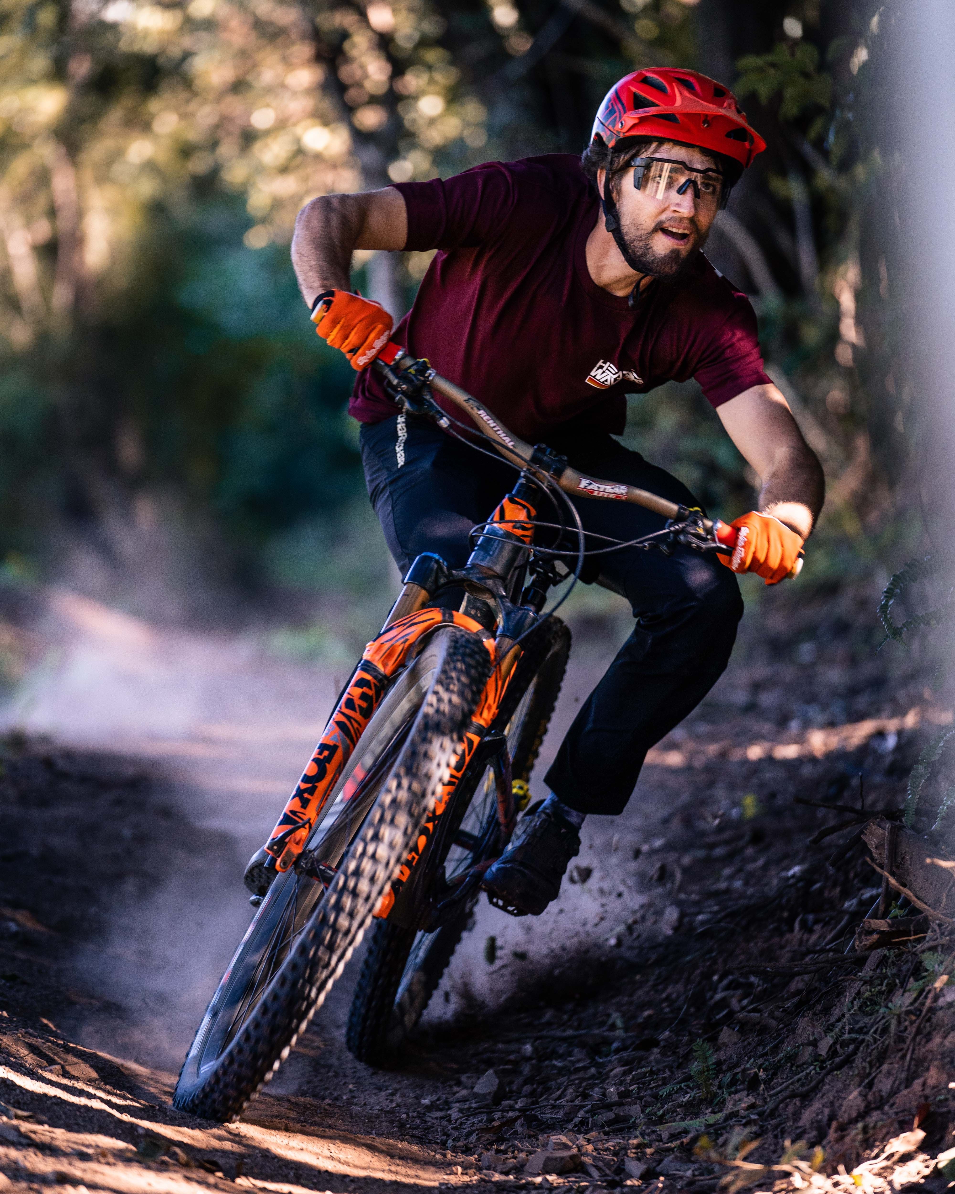 Mountain biker wearing Heat Wave Visual Future Tech Sunglasses with black frame and clear lens.