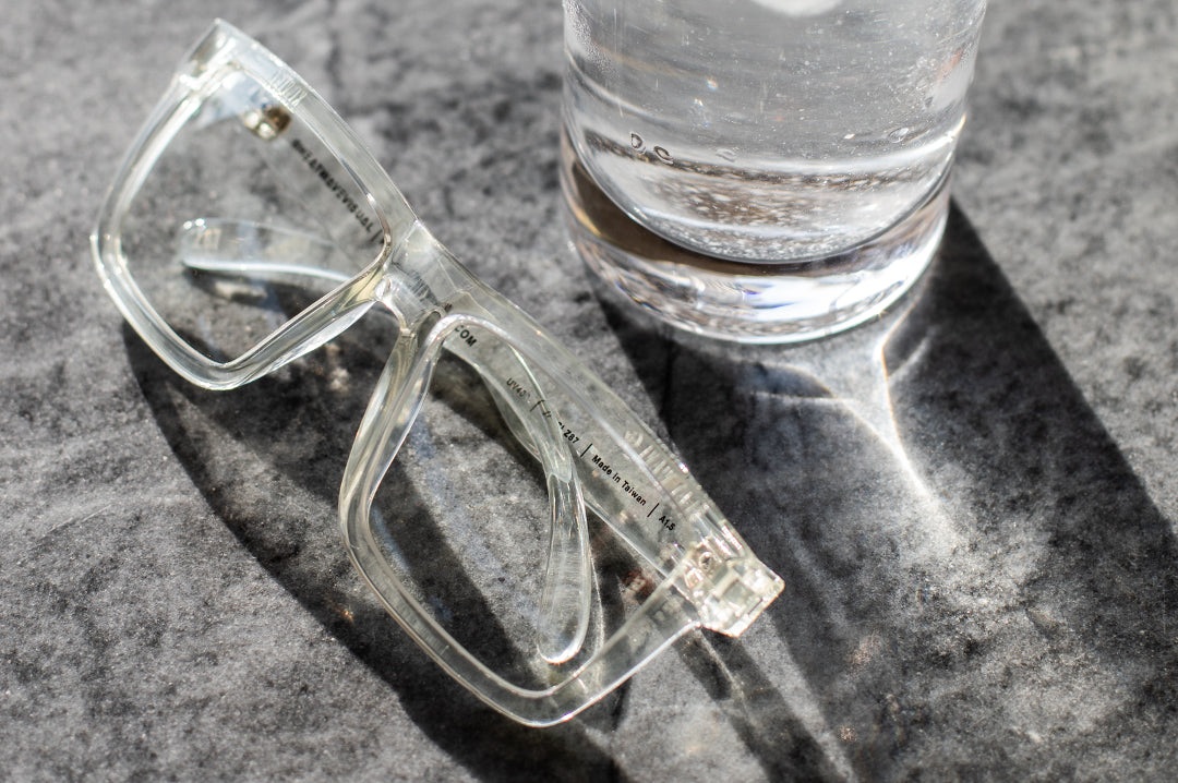 Heat Wave Visual XL Vise Sunglasses with clear frame and clear lenses on a granite table.