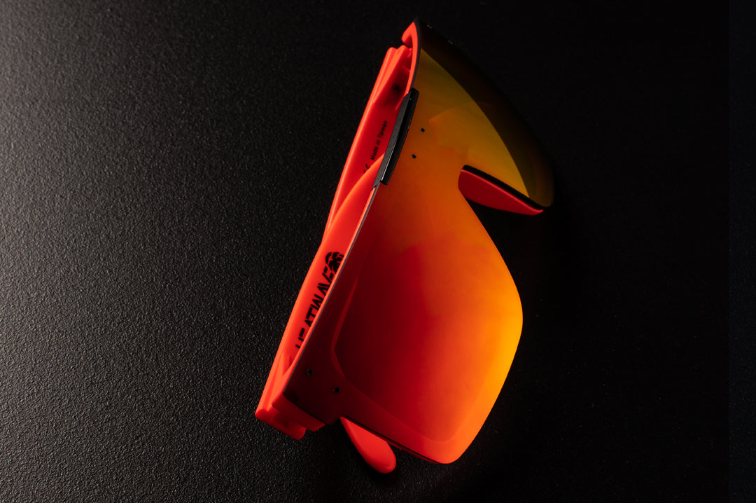 Close up of Heat Wave Visual Quatro Sunglasses with neon red frame, gridwave print arms and firestorm red lens.
