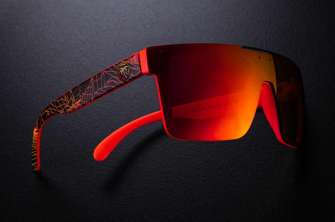Side view of Heat Wave Visual Quatro Sunglasses with neon red frame, gridwave print arms and firestorm red lens.