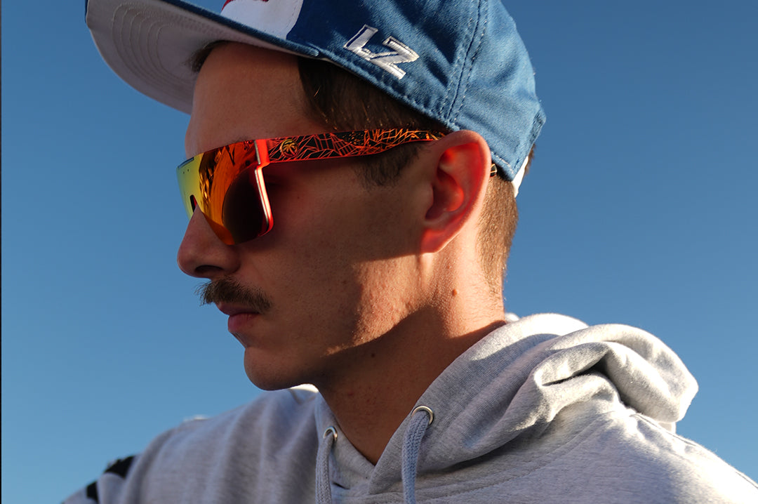 Youtuber Adam LZ wearing Heat Wave Visual Quatro Sunglasses with neon red frame, gridwave print arms and firestorm red lens.