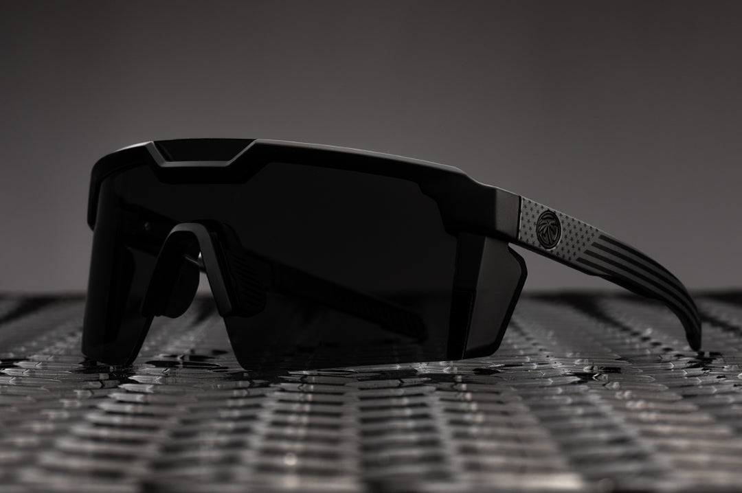 Heat Wave Visual Future Tech Sunglasses with black frame with SOCOM print arms and black lens.