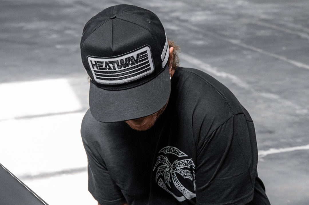 Man wearing the Heatwave Alloy Hat and looking down towards the ground.