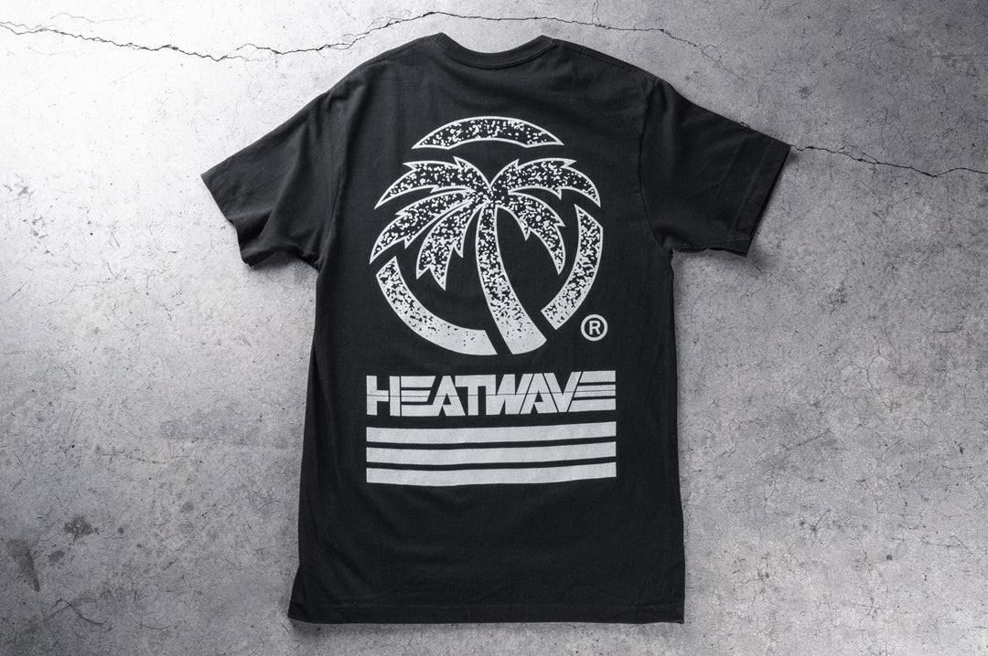 Backside shot of the Heat Wave Alloy T-Shirt on a concrete floor.