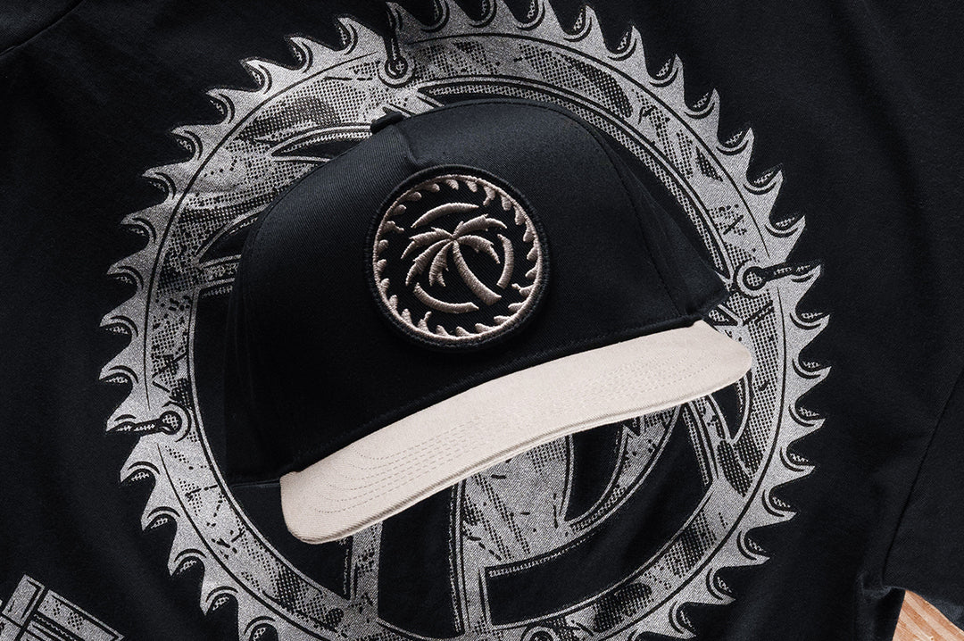 Black Snapback Hat with Silver Embroidered Patch
