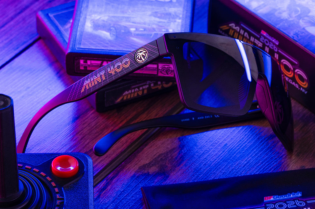 Sunglasses with a brand logo on a gaming console and controller setup