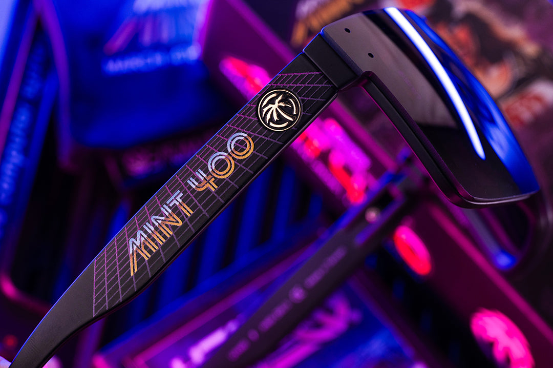 Sunglasses with 'Mint 400' branding on a colorful background