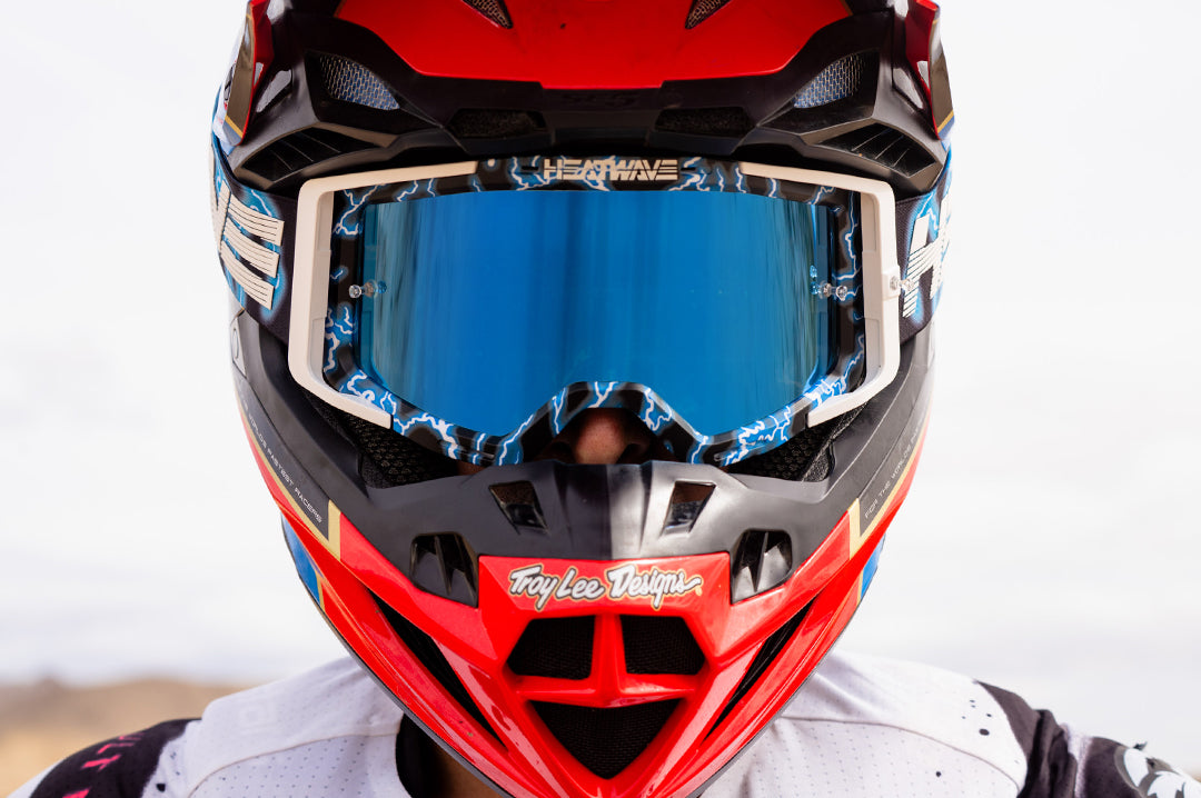 Action shot of a man in the desert wearing the Heat Wave Visual MXG 250 Motosport Goggle in the Lightning color way.