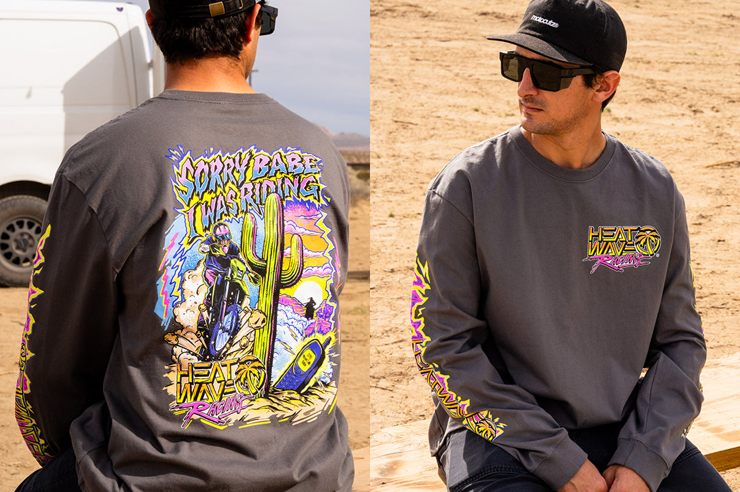 Man wearing the Heat Wave "Sorry Babe" LONG SLEEVE T-Shirt sitting in the desert.