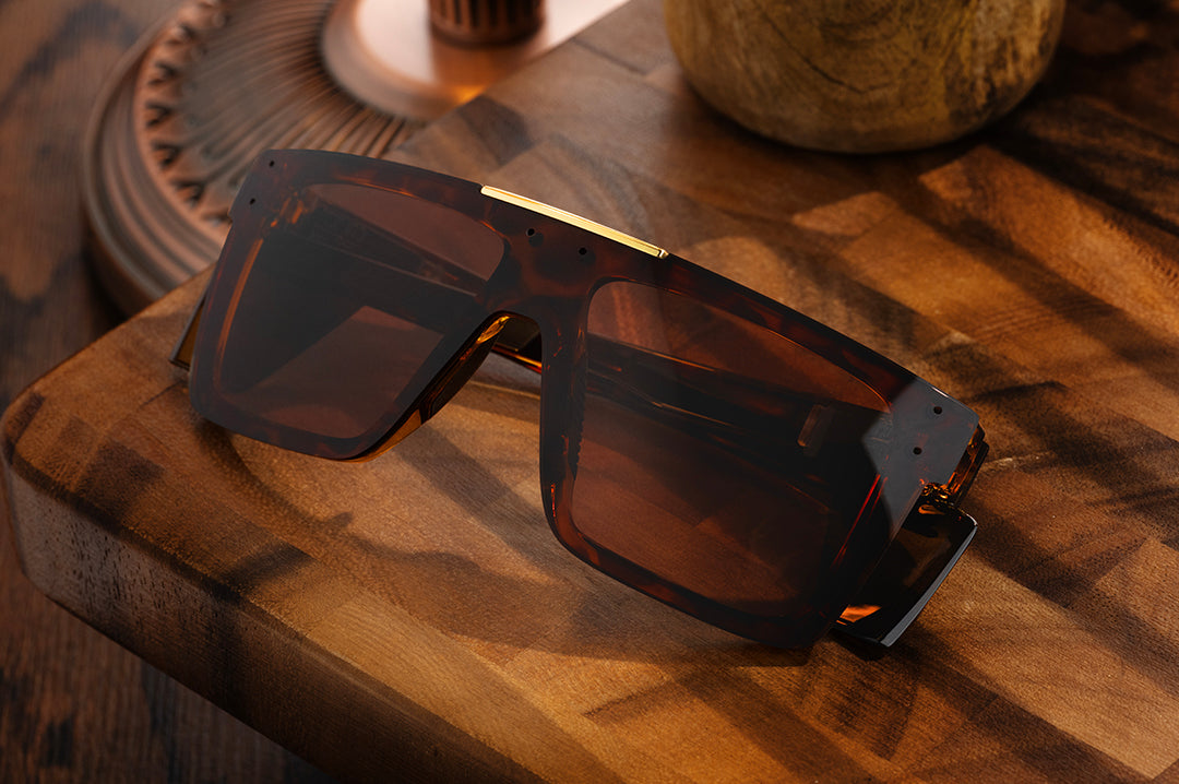 Front of Heat Wave Z87+ Performance Quatro Tortoise safety sunglasses sitting on wooden table.
