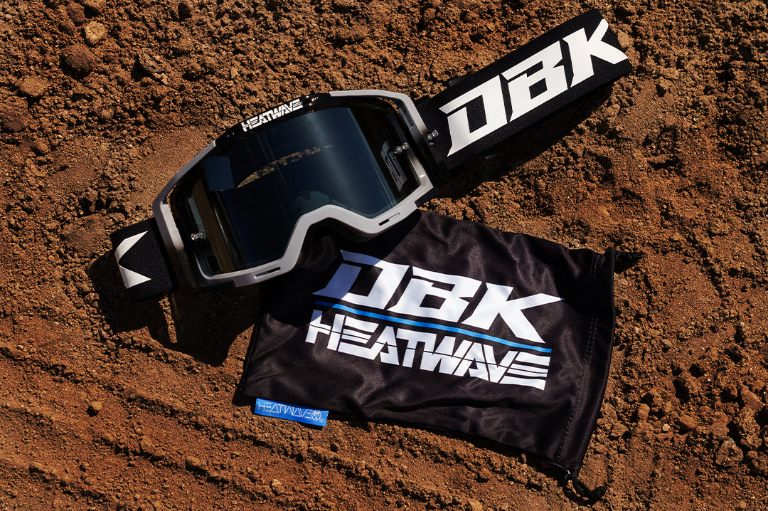 On the dirt is the Heat Wave Visual x DBK MXG-250 Moto Goggles.