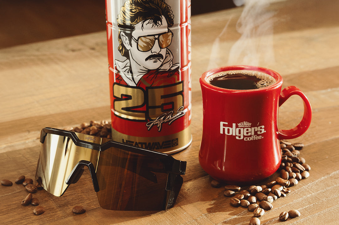 The Future Tech Sunglasses: Hendrick Motorsports | Tim Richmond 25 Folgers on a table next to product case and cup of coffee