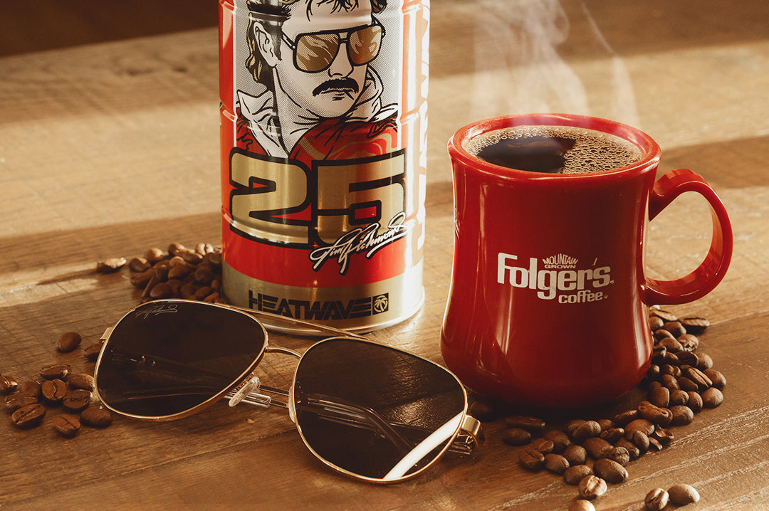 The Incline Sunglasses: Hendrick Motorsports | Tim Richmond 25 Folgers next to product case and a cup of coffee