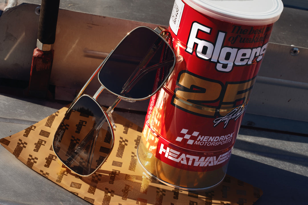 The Nimitz Sunglasses: Hendrick Motorsports | Tim Richmond 25 Folgers leaning against product case