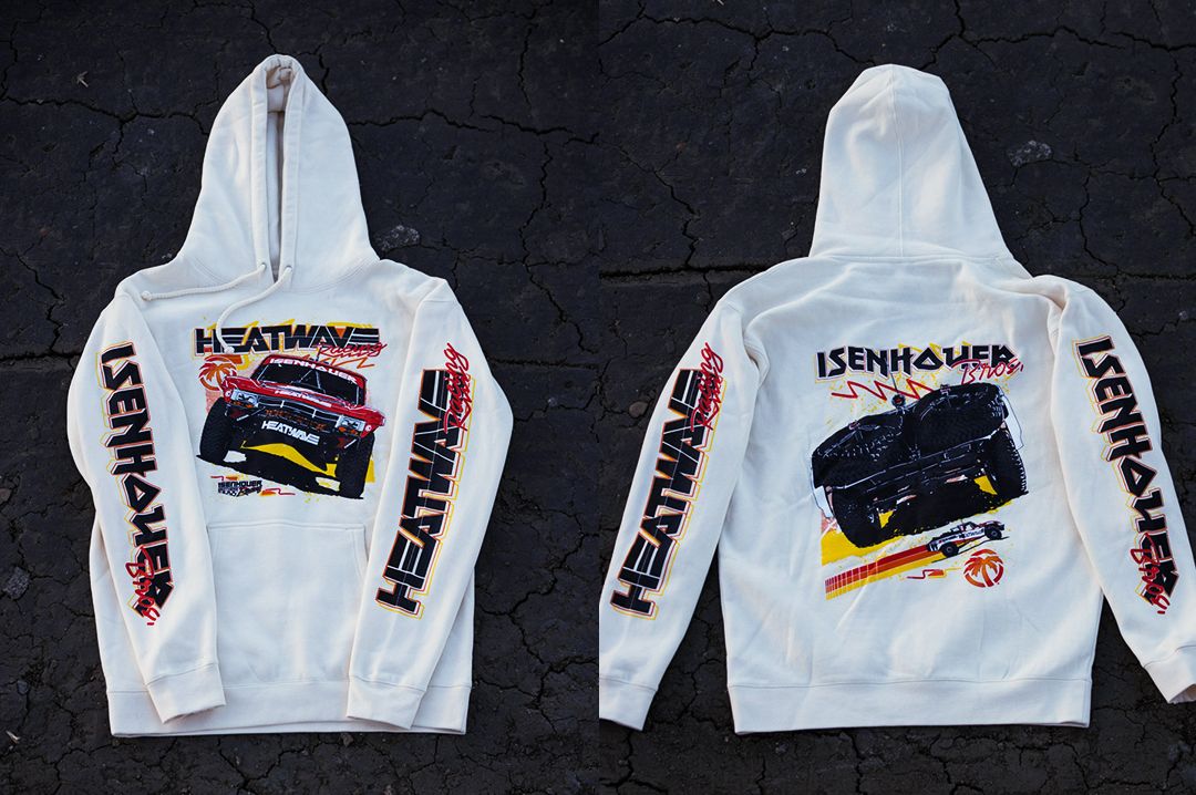 Lying down on asphalt is the Heat Wave Visual Isenhouer Racing Sweatshirt.