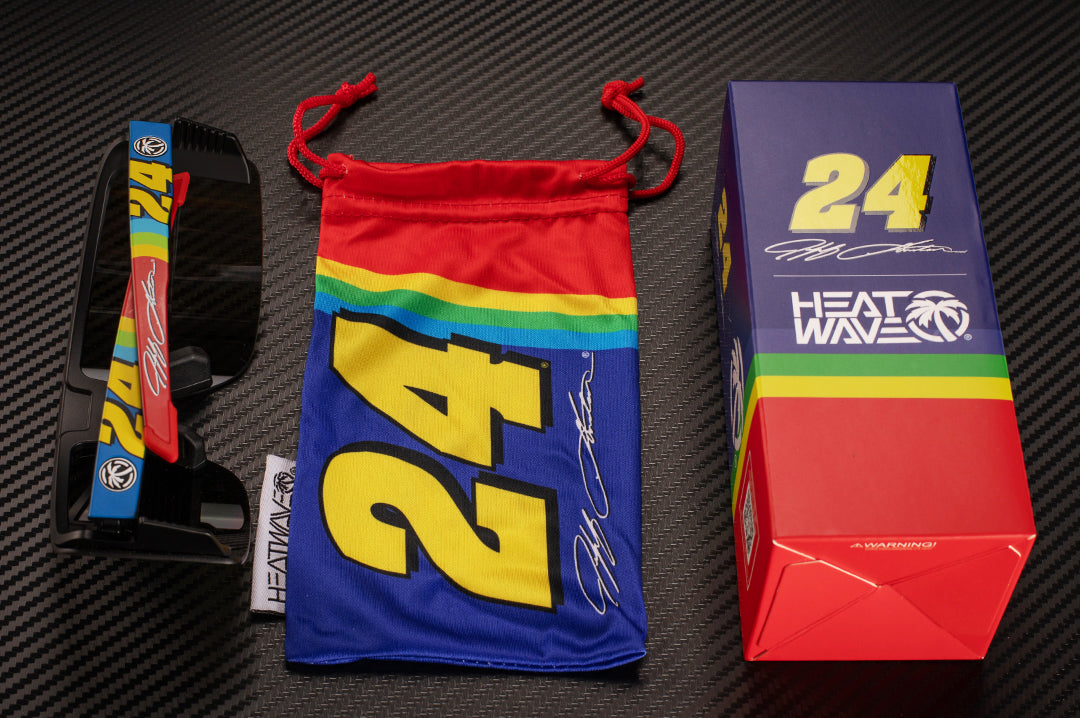 Lying on a table is the Heat Wave Visual x Jeff Gordon 24 Vector Sunglasses with matching microfiber and box. 