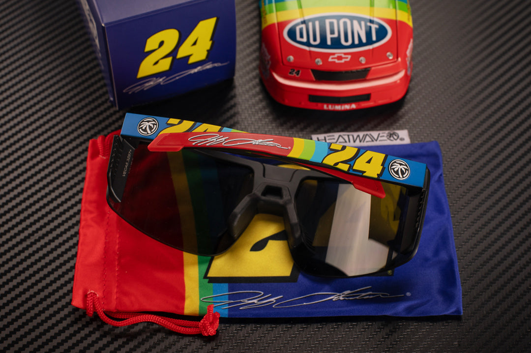 On a table is the Heat Wave Visual x Jeff Gordon #24 Vector Sunglasses. 