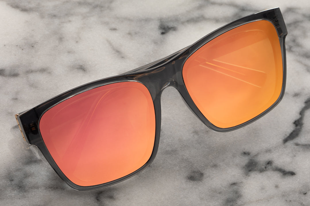 Lying on a marble slab is the Heat Wave Visual Marylin Sunglasses with quartz frames and rose gold lenses.