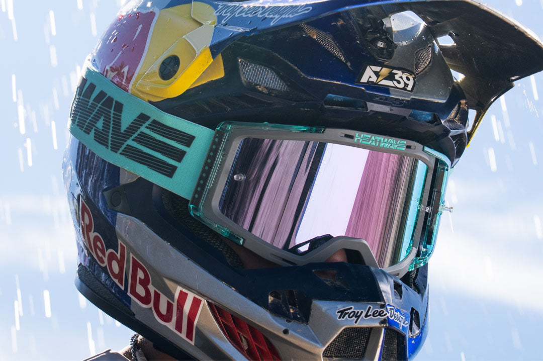 Male model wearing Heat Wave Hydro Aquastone Goggles with Ultra Violet Lens and Aqua colored strap