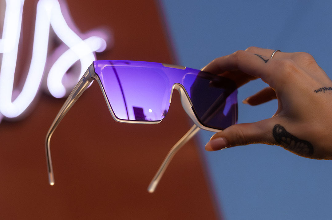 Hand holding Heat Wave Clarity with Vapor Frost Frame and Purple Lenses