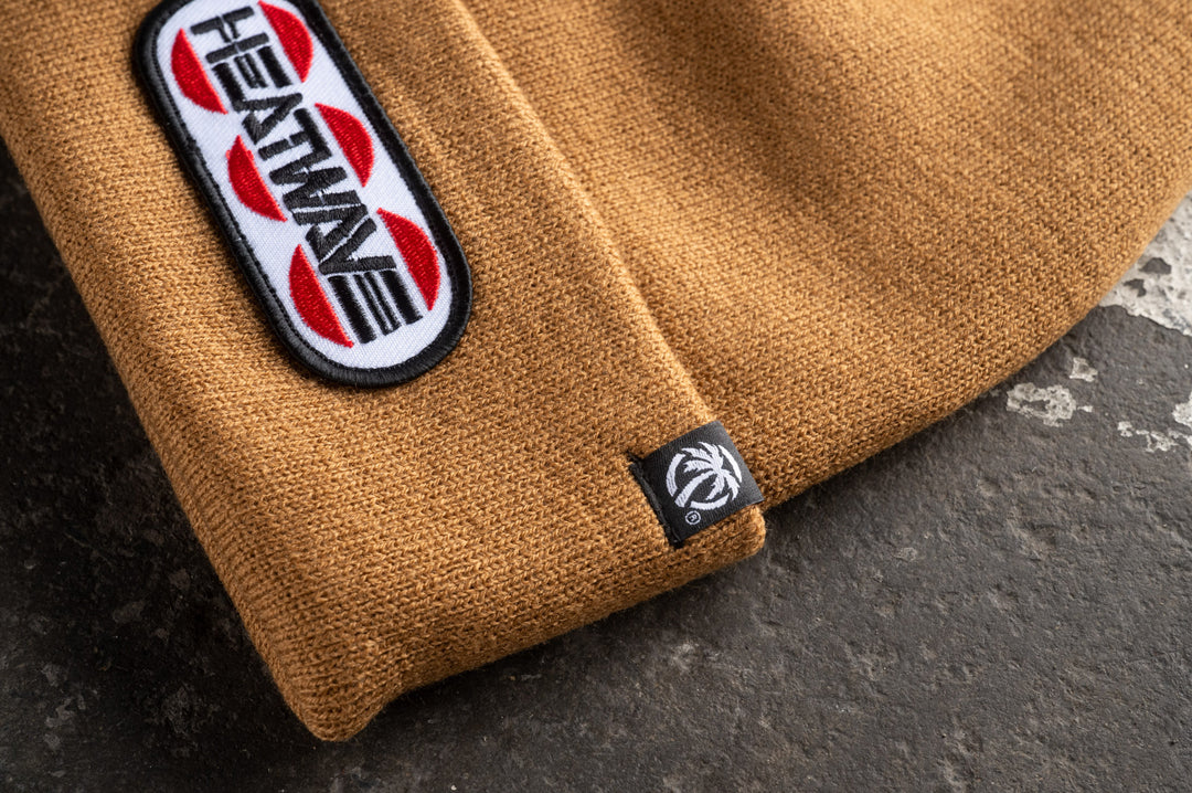 Close up of the logo on the Heat Wave Visual Butterfly Oatmeal Beanie.