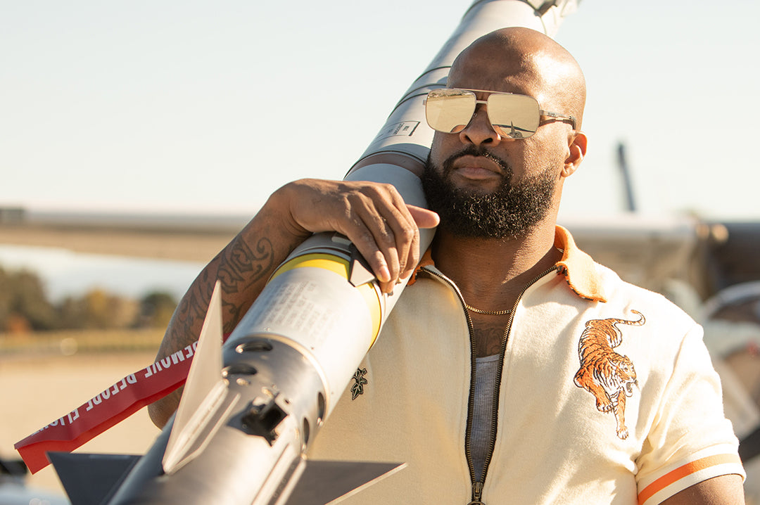 Ryan carrying a missile while rocking the Heat Wave Visual Nimitz Sunglasses with gun metal frame and silver lenses.