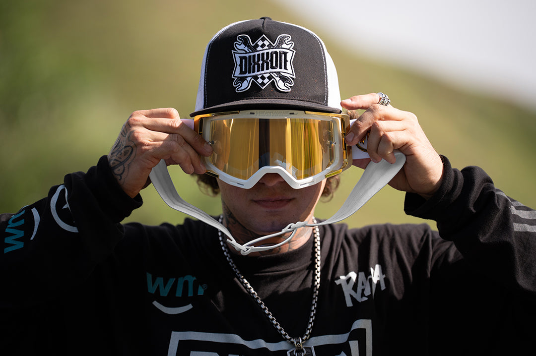 Colby Raha holding up The MXG-250 Moto Goggle - Colby Raha 2.0 to his face  outside