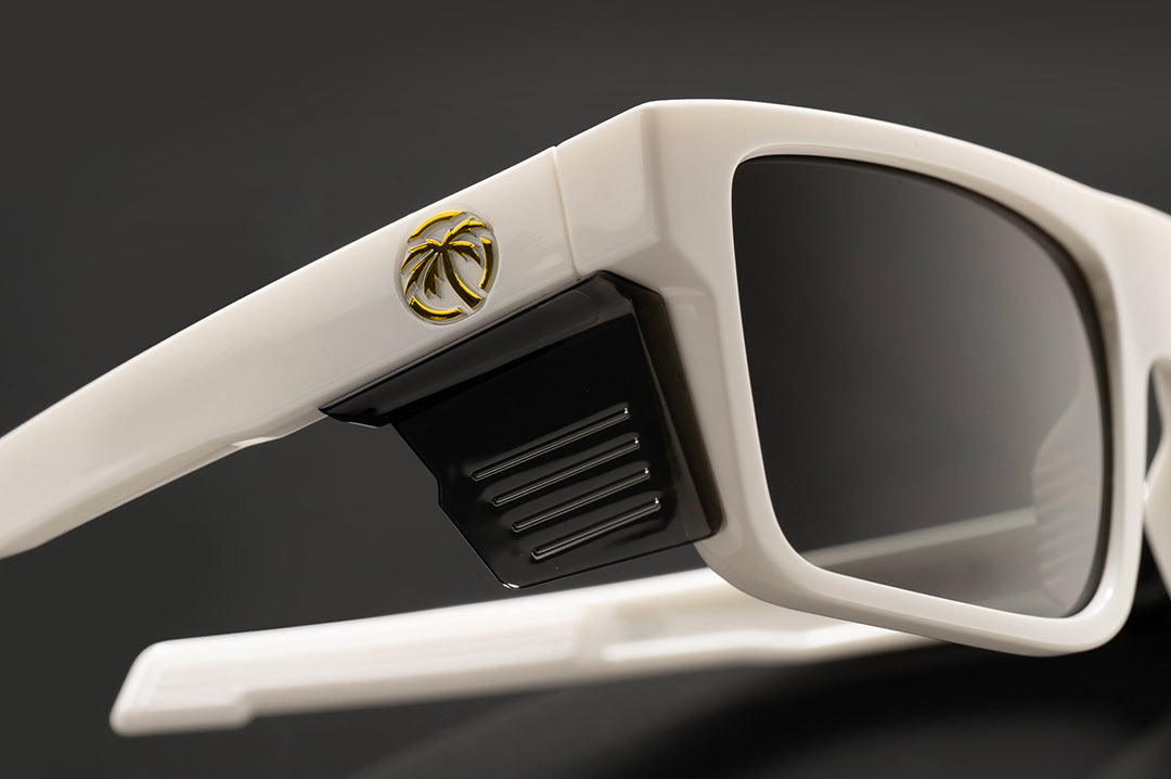 Close up studio shot of The Performance Rayth Sunglasses: Colby Raha 2.0 with black side shields on a black background