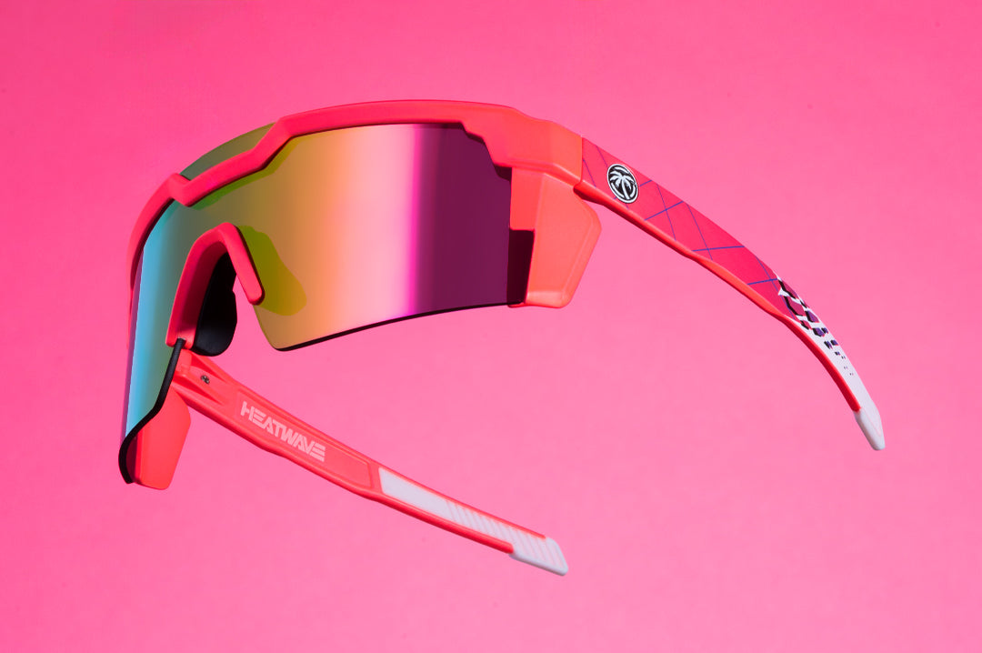 Side of Heat Wave Visual Future Tech Sunglasses with pink frames, standup arms and spectrum pink yellow lens.