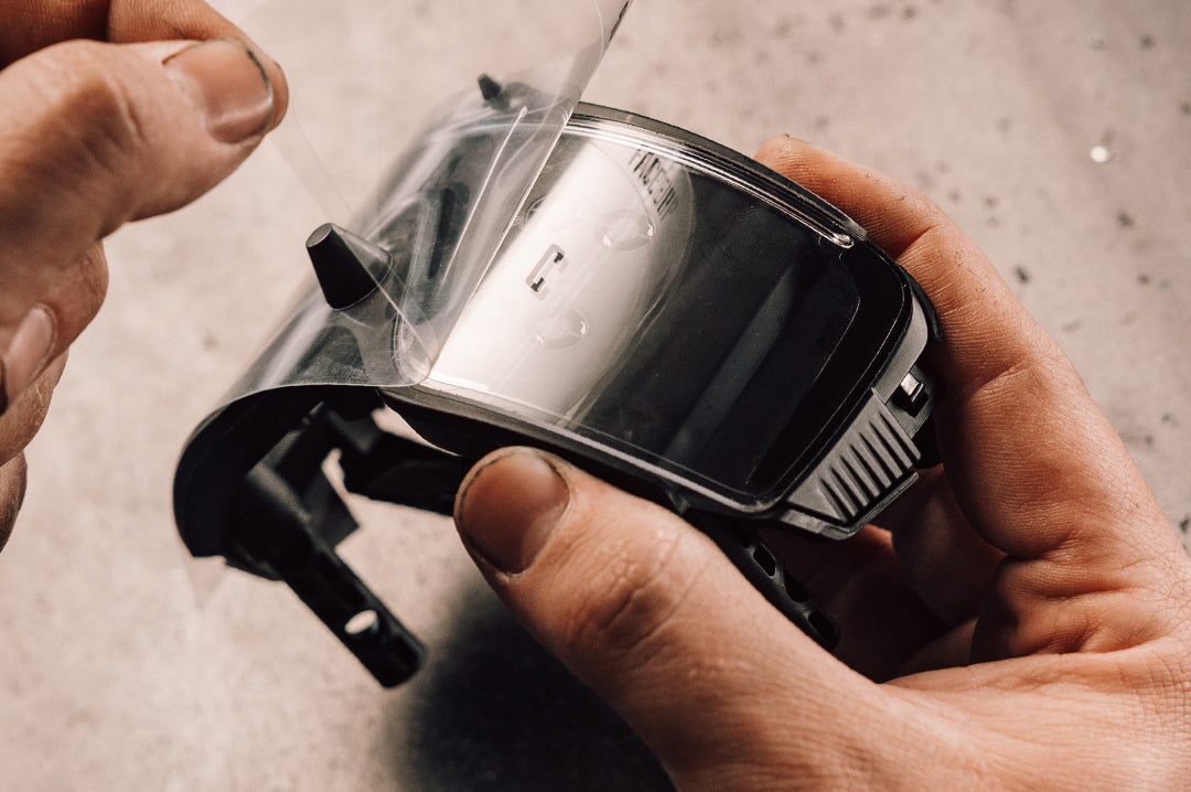 Person peeling off the Skynet Replacement LPF Lens Protection Film off glasses