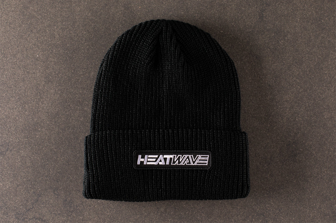 Lying on concrete is the Heat Wave Visual Split Billboard Black Beanie.