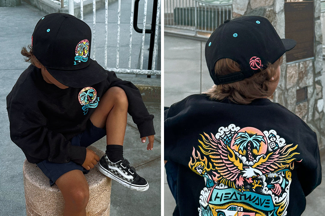 Boy wearing the Heat Wave x Tall Boy Youth Icon Flash Hat - Black showing front and back side