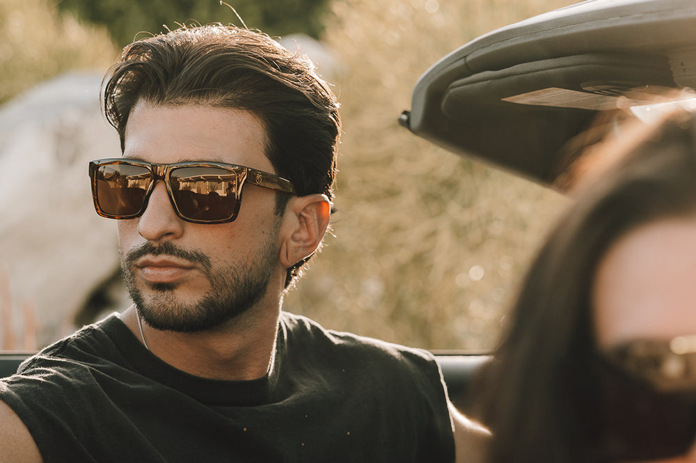 Young Dude in his car rocking the Heat Wave Visual Performance XL Vise Sunglasses with tortoise frame, brown lenses and matching sides shields.